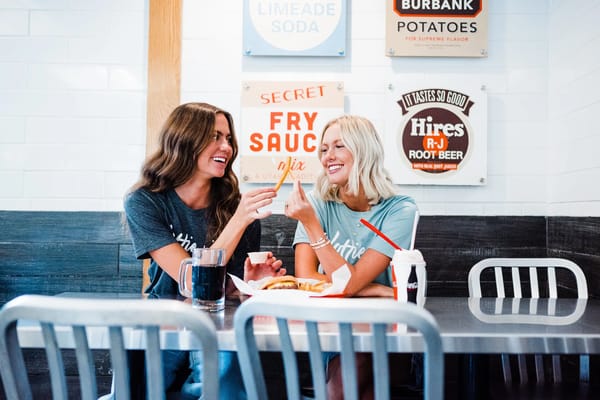 Friends sharing burgers at Hires Big H