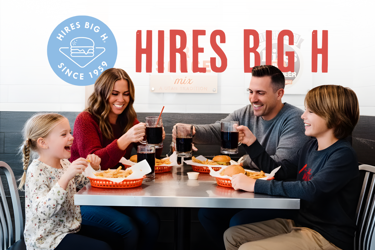 A multi-generational family, including a mother, father, daughter, son, and grandmother, happily share burgers and drinks around a table inside a Hires Big H restaurant, creating cherished memories over the best burger in Utah.